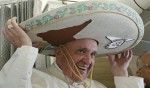 Pope Francis wears a traditional Mexican sombrero hat he received as a gift by a Mexican journalist aboard the plane during the flight from Rome to Habana, Cuba, on his way to a week-long trip to Mexico, Friday, Feb. 12, 2016. The pontiff is scheduled to stop in Cuba for an historical meeting with Russian Orthodox Patriarch Kirill that the Vatican sees as a historic step in the path toward healing the 1,000-year schism that split Christianity. (Alessandro Di Meo/Pool Photo via AP)